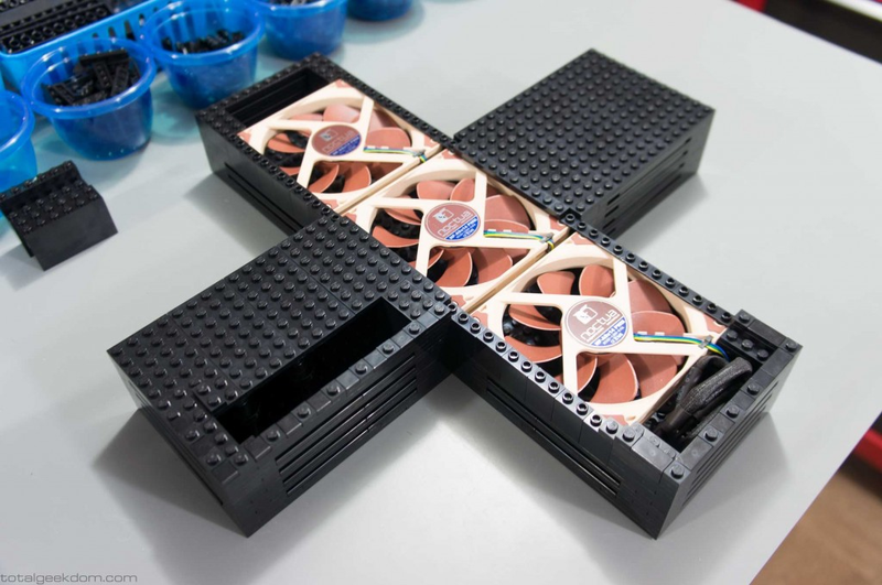 The motherboard is mounted above these system fans.